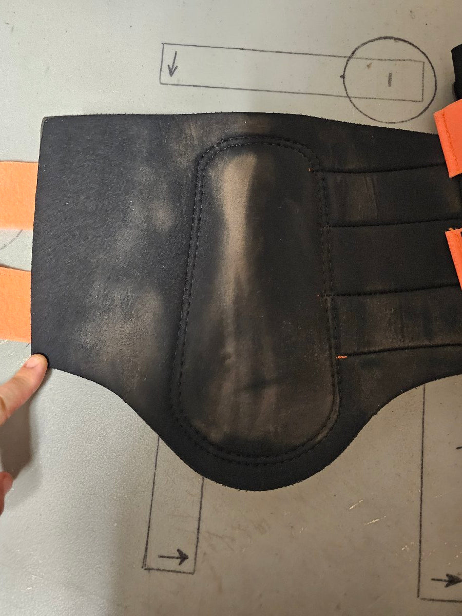 Large orange and black Woof Wear brushing boots Large
